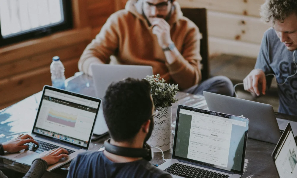 Men sitting around a table working.