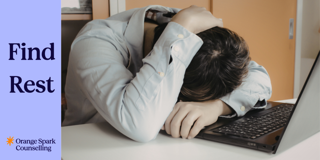 Overworked man at work with head on desk