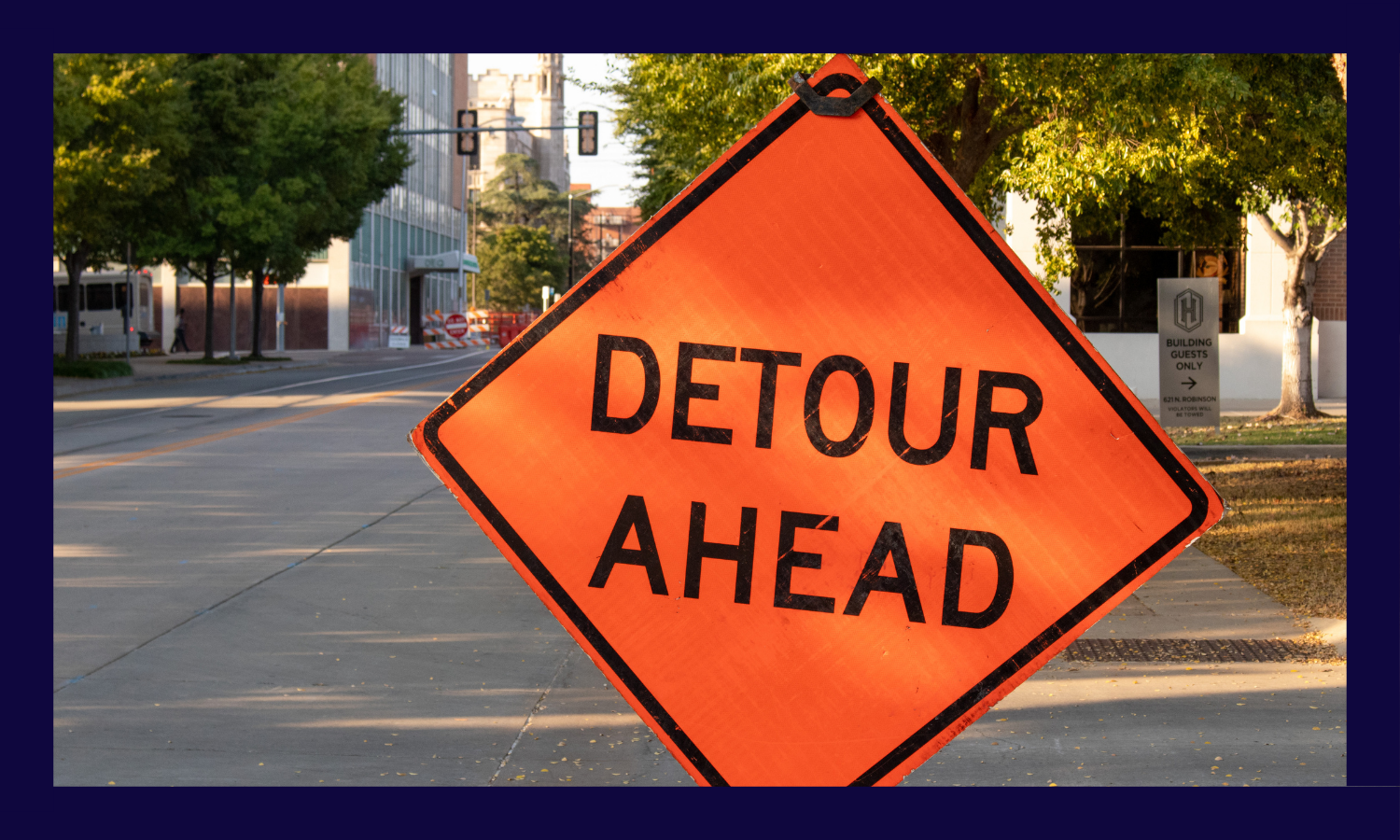 Detour sign with road construction in background