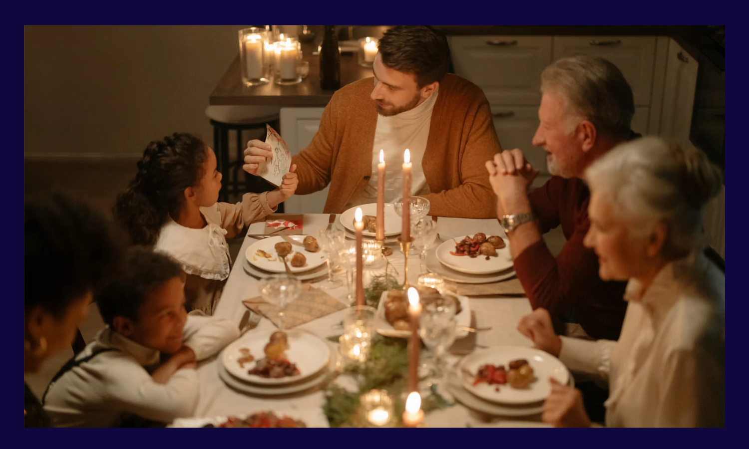 Man and his family sitting around a dinner table